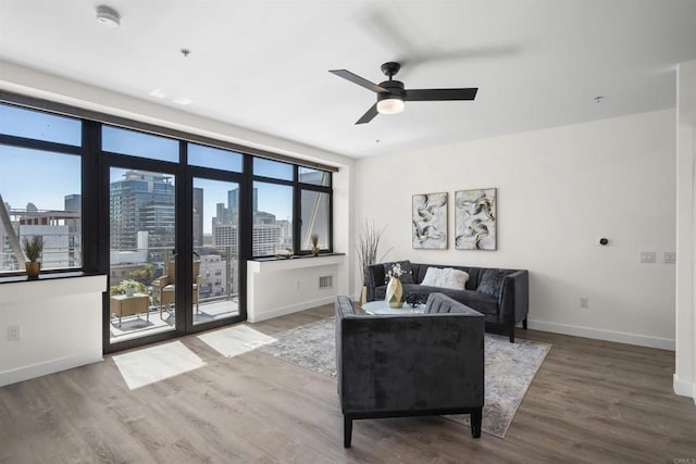 1551 4th Ave Unit 611, San Diego, CA 92101 - living area featuring a ceiling fan, baseboards, a wealth of natural light, and wood finished floors