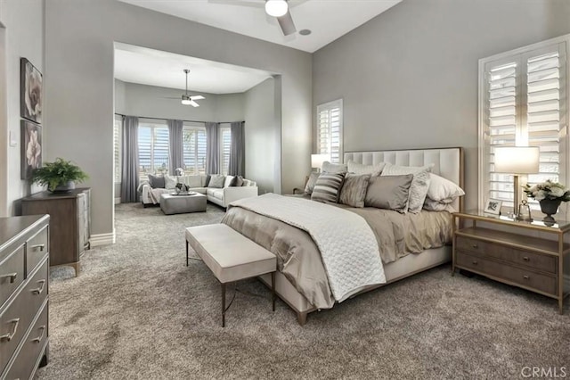 carpeted bedroom featuring ceiling fan and baseboards