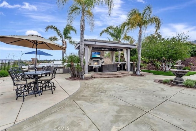 view of patio / terrace featuring an outdoor living space, fence, and a gazebo