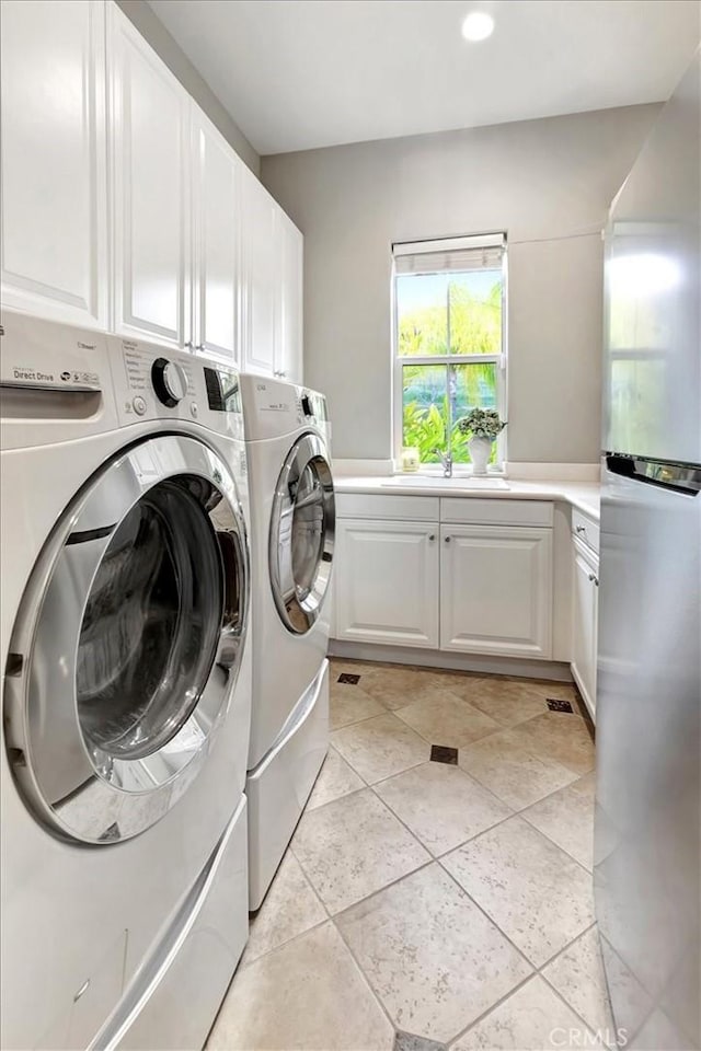 washroom with independent washer and dryer, cabinet space, a sink, recessed lighting, and light tile patterned flooring
