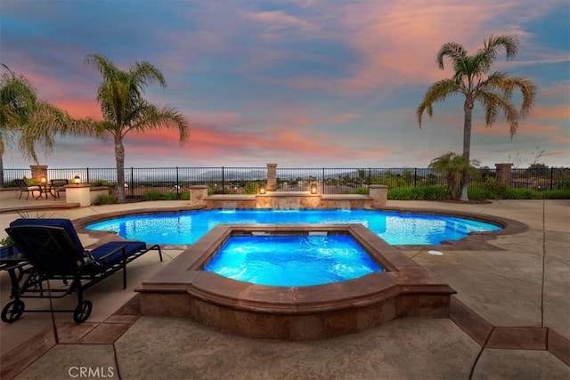 view of pool featuring a fenced in pool, a fenced backyard, an in ground hot tub, and a patio area