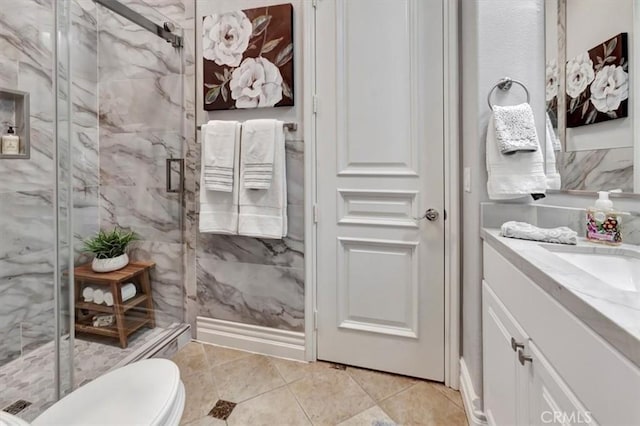 bathroom with toilet, tile patterned floors, a marble finish shower, and vanity
