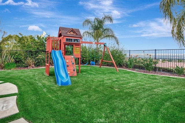 view of playground with fence and a yard
