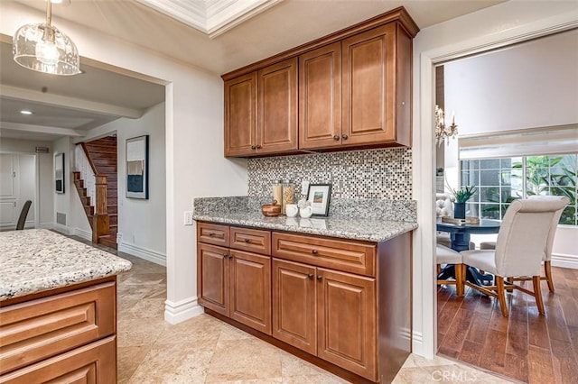 756 N Malden Ave, Fullerton, CA 92832 - kitchen with backsplash, brown cabinets, beam ceiling, light stone countertops, and baseboards