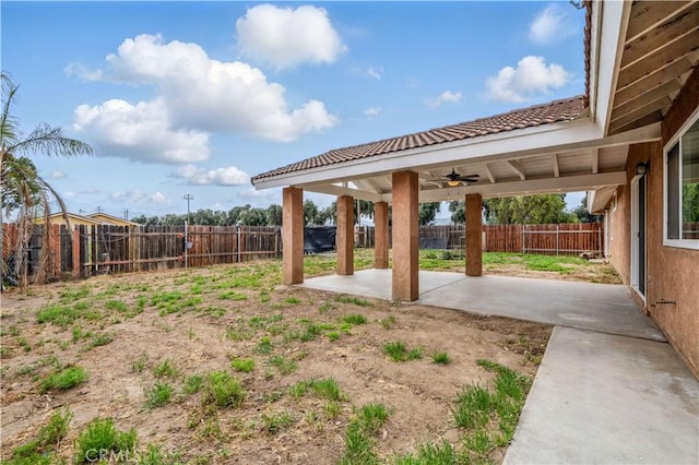 view of yard with a fenced backyard, a patio area, and a ceiling fan