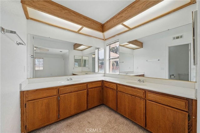 full bath with carpet flooring, visible vents, a sink, and double vanity