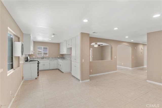 kitchen with white cabinets, light countertops, white dishwasher, recessed lighting, and gas stove