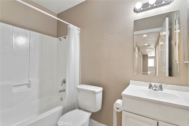 bathroom with vanity, shower / bath combination with curtain, toilet, a textured wall, and baseboards