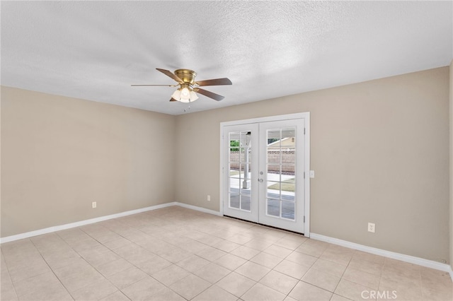 empty room with light tile patterned flooring, ceiling fan, baseboards, a textured ceiling, and french doors