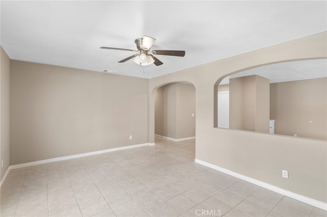 spare room featuring baseboards, visible vents, light tile patterned floors, and a ceiling fan