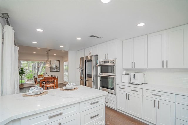 2217 Serrano Pl, Fullerton, CA 92833 - kitchen featuring white cabinets, light stone countertops, stainless steel appliances, recessed lighting, and visible vents