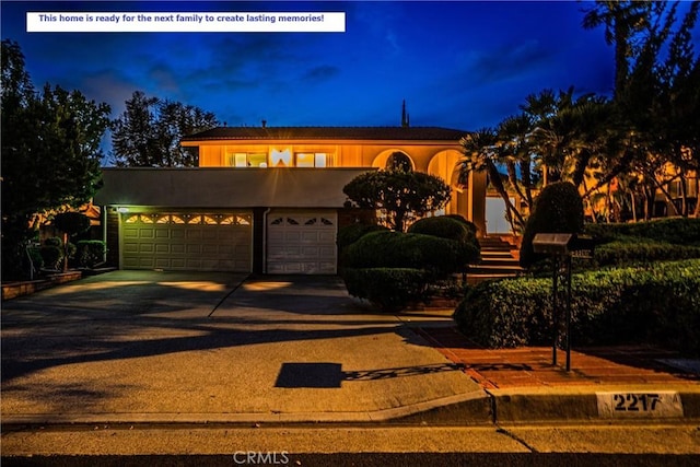 2217 Serrano Pl, Fullerton, CA 92833 - view of front of home with a garage, stucco siding, and driveway