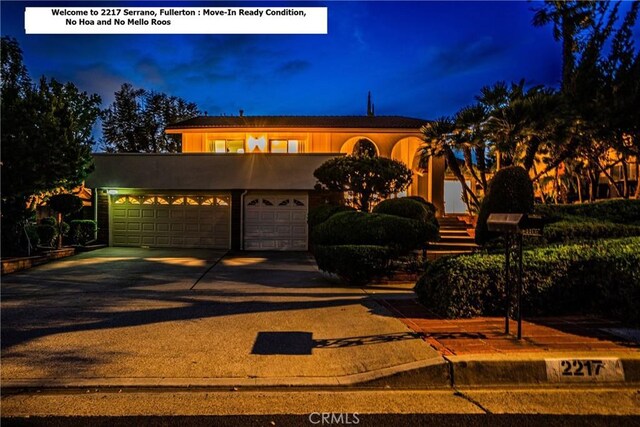 2217 Serrano Pl, Fullerton, CA 92833 - view of front of home featuring an attached garage, driveway, and stucco siding