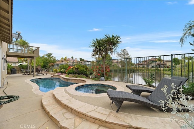 view of swimming pool featuring a fenced backyard, a fenced in pool, a water view, a patio, and an in ground hot tub