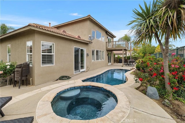 outdoor pool with a patio, a fenced backyard, and an in ground hot tub