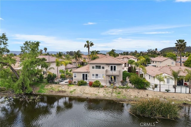 exterior space with a residential view and a water view