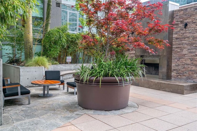 view of patio / terrace with an outdoor stone fireplace