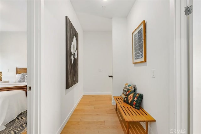 hall featuring baseboards and light wood-style floors