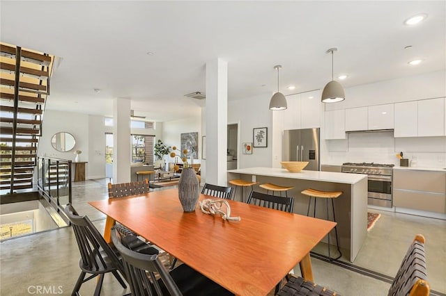 dining area featuring visible vents, finished concrete flooring, and recessed lighting