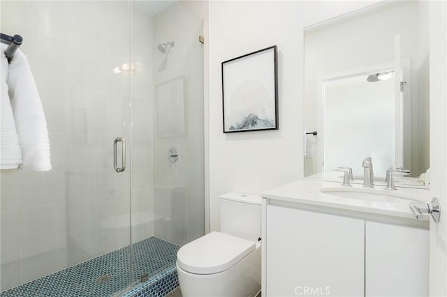 full bath with a shower stall, toilet, and vanity