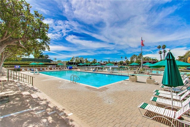 pool featuring a patio and fence