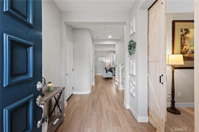 entryway with baseboards, recessed lighting, and light wood-style flooring