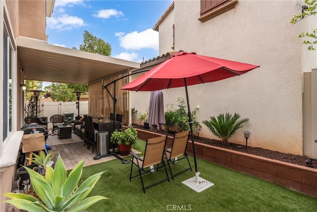 view of patio featuring fence and an outdoor living space