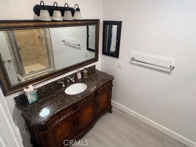 32679 Seagate Dr Unit 308-H, Rancho Palos Verdes, CA 90275 - bathroom featuring baseboards, wood finished floors, and vanity