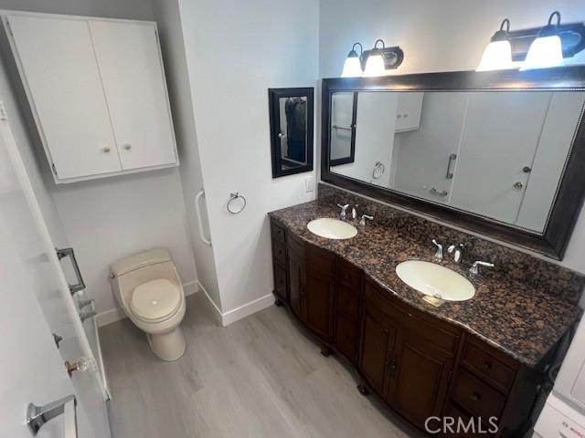 32679 Seagate Dr Unit 308-H, Rancho Palos Verdes, CA 90275 - full bathroom with baseboards, a sink, wood finished floors, and toilet