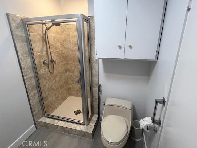 32679 Seagate Dr Unit 308-H, Rancho Palos Verdes, CA 90275 - bathroom with baseboards, a shower stall, and toilet