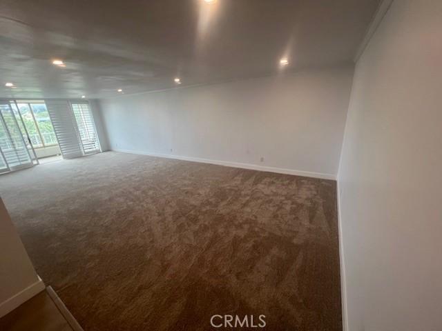 32679 Seagate Dr Unit 308-H, Rancho Palos Verdes, CA 90275 - unfurnished room featuring crown molding, a wall of windows, baseboards, recessed lighting, and carpet flooring