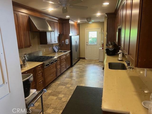 32679 Seagate Dr Unit 308-H, Rancho Palos Verdes, CA 90275 - kitchen with a sink, wall chimney range hood, light countertops, a ceiling fan, and stainless steel appliances