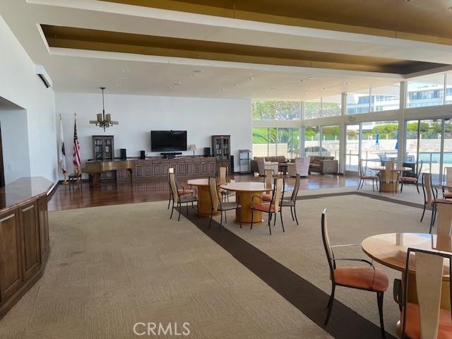 32679 Seagate Dr Unit 308-H, Rancho Palos Verdes, CA 90275 - carpeted dining space with a chandelier and a healthy amount of sunlight