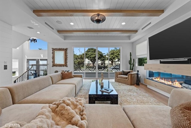 507 N Maria Ave Unit A, Redondo Beach, CA 90277 - living area with wood ceiling, wood finished floors, healthy amount of natural light, beam ceiling, and a glass covered fireplace