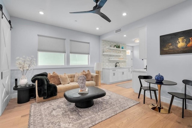 507 N Maria Ave Unit A, Redondo Beach, CA 90277 - living area with a barn door, light wood-style floors, ceiling fan, baseboards, and recessed lighting