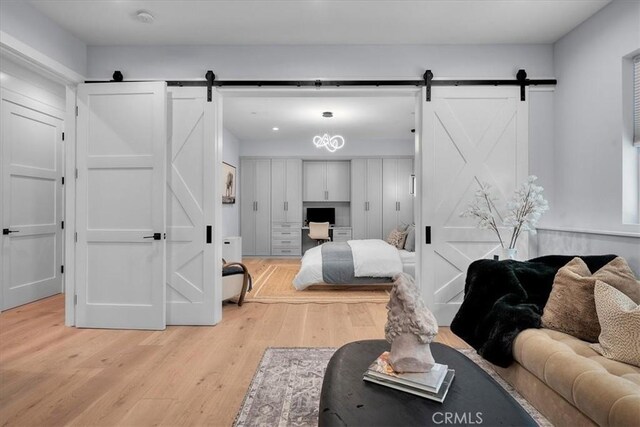 507 N Maria Ave Unit A, Redondo Beach, CA 90277 - bedroom with a barn door, light wood finished floors, and a desk