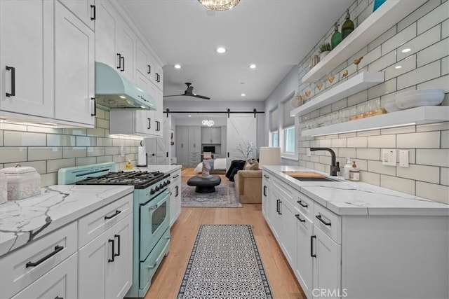 507 N Maria Ave Unit A, Redondo Beach, CA 90277 - kitchen with stainless steel gas range, open shelves, a sink, a barn door, and under cabinet range hood