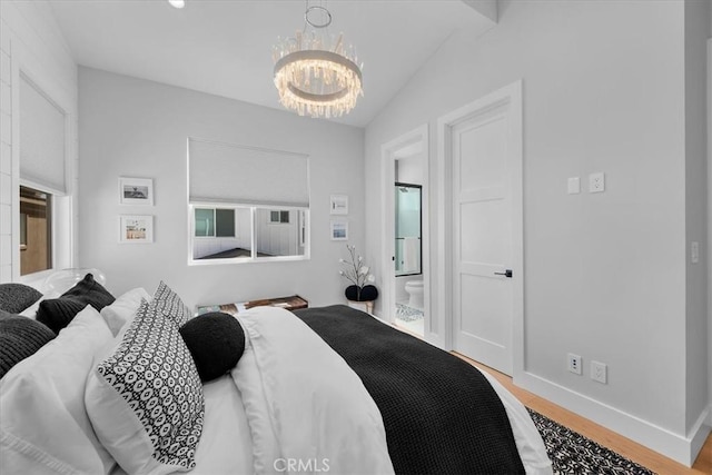 507 N Maria Ave Unit A, Redondo Beach, CA 90277 - bedroom with a chandelier, wood finished floors, baseboards, connected bathroom, and vaulted ceiling