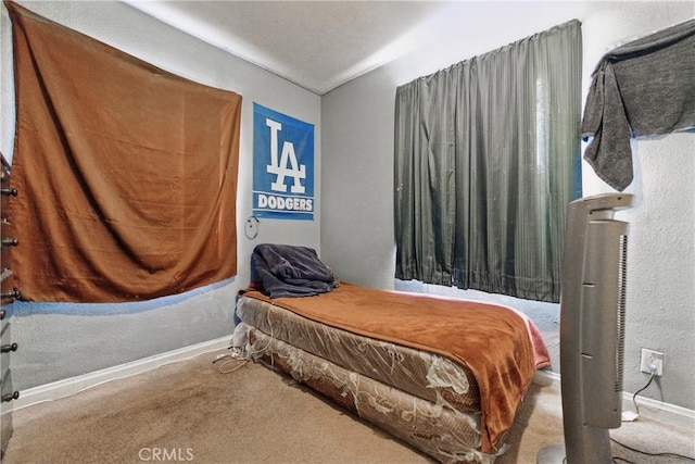 907 E 109th Pl, Los Angeles, CA 90059 - carpeted bedroom with baseboards and a textured wall