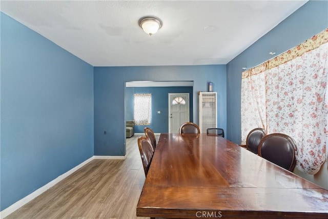 907 E 109th Pl, Los Angeles, CA 90059 - dining room with baseboards, a heating unit, and wood finished floors