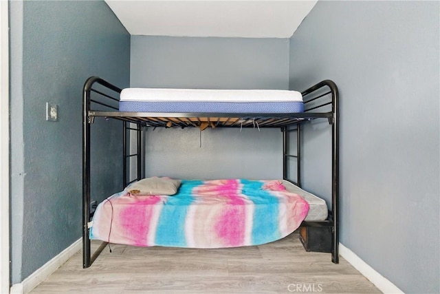907 E 109th Pl, Los Angeles, CA 90059 - bedroom featuring baseboards and wood finished floors