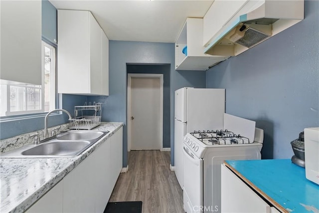 907 E 109th Pl, Los Angeles, CA 90059 - kitchen with white cabinetry, white range with gas stovetop, and a sink