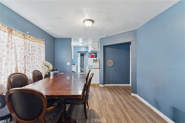 907 E 109th Pl, Los Angeles, CA 90059 - dining area featuring baseboards and wood finished floors