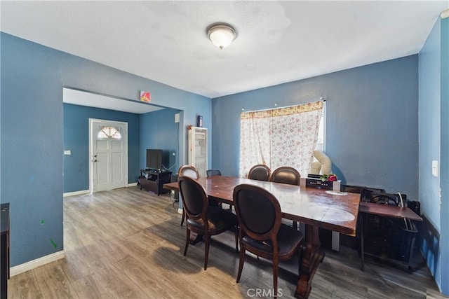 907 E 109th Pl, Los Angeles, CA 90059 - dining area with baseboards, a textured wall, and wood finished floors