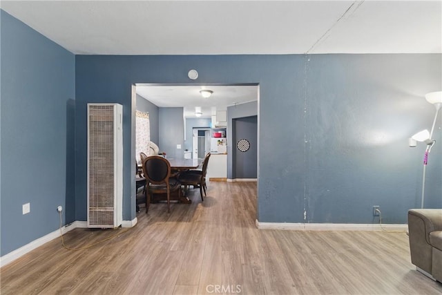 907 E 109th Pl, Los Angeles, CA 90059 - dining area featuring baseboards, a heating unit, and wood finished floors