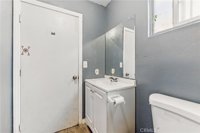 907 E 109th Pl, Los Angeles, CA 90059 - bathroom featuring toilet, wood finished floors, and vanity