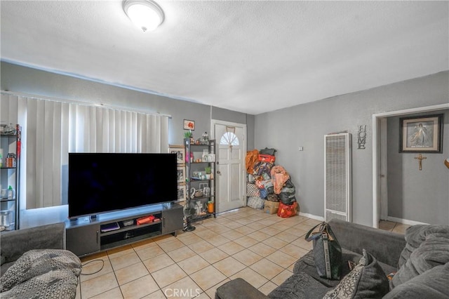 907 E 109th Pl, Los Angeles, CA 90059 - living room featuring tile patterned floors, a textured ceiling, and a heating unit
