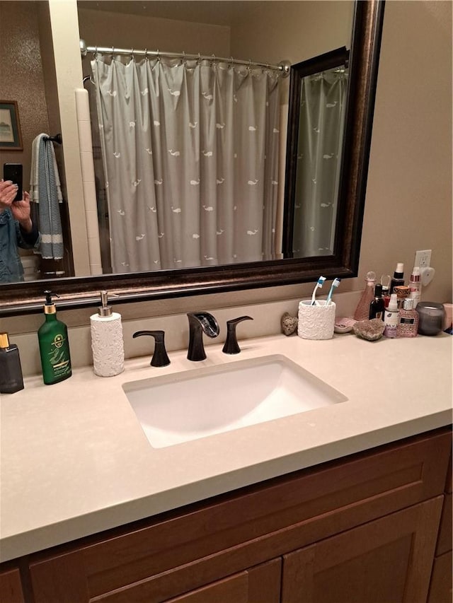 bathroom with vanity and curtained shower
