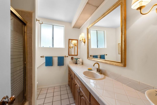 bathroom featuring an enclosed shower, a wealth of natural light, tile patterned flooring, and vanity