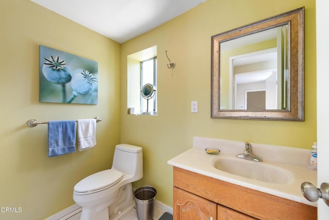 bathroom featuring baseboards, vanity, and toilet